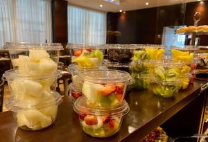 a table topped with plastic containers filled with fruit at Hotel Principe di Piemonte in Rimini