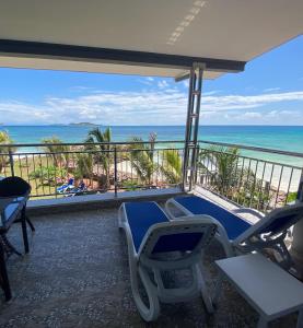 a balcony with chairs and a view of the beach at Treasure Island Retreat in Anse Kerlan