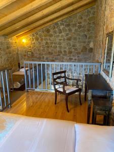 1 dormitorio con silla y escritorio en una habitación en Angelic in the mountains, en Kaisárion
