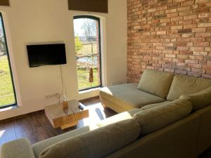 a living room with a couch and a brick wall at Schöner Winkel in Schafwinkel +31 photos