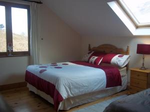 a bedroom with two beds and a window at Mountainview B&B in Leenaun