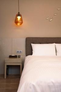 Postel nebo postele na pokoji v ubytování Hub Hotel Kaohsiung Yawan Branch