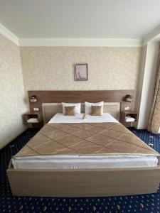 1 dormitorio con 1 cama grande en una habitación en "Palazzo", en Kostanái