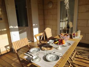 a table with plates of food and a bowl of fruit at La maison botanique in Castillon-la-Bataille +26 photos