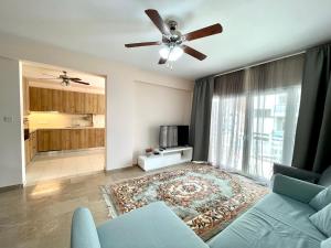 a living room with a couch and a ceiling fan at 100 m to the beach Sea La Vie 3 bedroom Apartment in Limassol