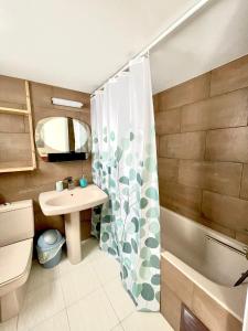 a bathroom with a sink and a shower curtain at 100 m to the beach Sea La Vie 3 bedroom Apartment in Limassol