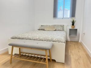 a small bedroom with a bed and a stool at Casa del olivo in Almuñécar +43 photos