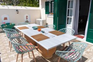 a table and chairs on a patio at La belle Hélène in Spetses
