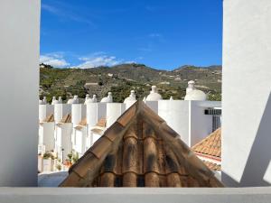 a view of a white building with a roof at Casa del olivo in Almuñécar