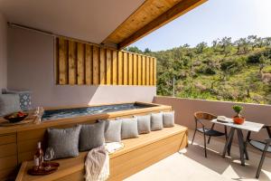 una vista dal balcone di una casa con vasca idromassaggio di Skiathos Avaton Suites & Villas, Philian Hotels and Resorts a Megali Ammos