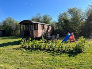 a tiny house in a field with a playground at Pipowagen voor 4 personen in Diever