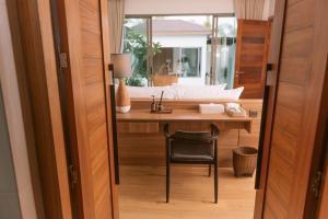 a room with a desk with a sink and a chair at Villa Alanna Phuket in Bang Tao Beach