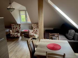 a living room with a table and chairs at Willa Poranek in Krynica Zdrój