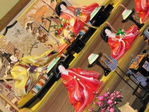 a group of dolls are on display in a store at Dyeing and Hostel Nakashimaya - Female Only in Kumamoto