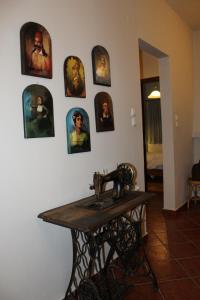 a bathroom with a sink and pictures on the wall at Centaurs View in Portariá