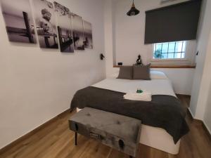 A bed or beds in a room at Budha Luxury Apartment Centro Histórico de Málaga