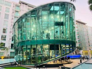 a glass building in front of a building at City Center Residence Condominium Pattaya RJ in Pattaya Central