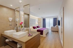 a hotel room with a large bed and a large window at Hotel Beverly Park & Spa in Blanes
