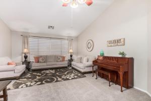 a living room with a piano and a couch at Baylor Gilbert home in Gilbert