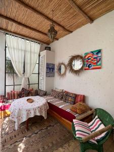 a living room with a couch and a table at RIAD OASIS D'ASILAH in Asilah +37 photos