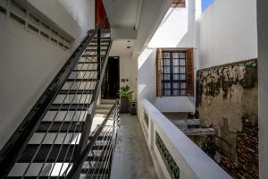 a staircase in a white building with a stair case at RARE Heritage House in George Town