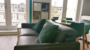 a living room with a couch and a table at Designed Penthouse, Amsterdam city center in Amsterdam