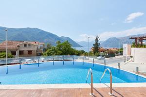 a large swimming pool with mountains in the background at Minka in Kotor