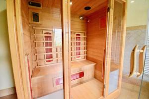 a walk in shower in a bathroom with wooden walls at VILLA NOCRI - Villa Privata con Piscina & Sauna in Montefranco +56 photos