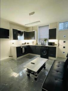 a large kitchen with a table in the middle of it at Entire 5 Star Luxury Whalley House Wifi TV Luxury in Burnley