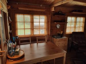 a dining room with a wooden table in a cabin at Cosy Cabin by Lake & Woods with Views in Selfoss