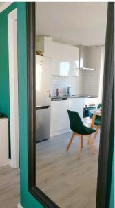 a kitchen with a green chair and a table at Designed Penthouse, Amsterdam city center in Amsterdam +24 photos