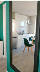 a kitchen with a green chair and a table at Designed Penthouse, Amsterdam city center in Amsterdam