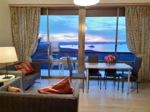 a living room with a couch and a table with a view at Belvedere del Lago in Montefiascone