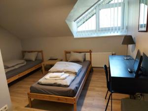 Zimmer mit 2 Betten, einem Schreibtisch und einem Fenster in der Unterkunft ,,Įlanka" in Rumšiškės