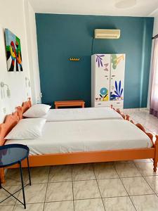 a bedroom with a large bed with a blue wall at Mitato Studios in Myrtos