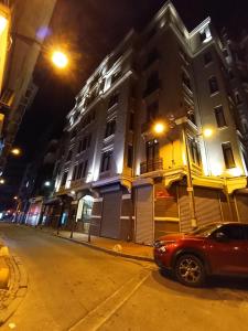 een auto die 's nachts voor een gebouw geparkeerd staat bij Star of İstanbul Residence in Istanbul