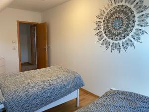 a bedroom with two beds and a mirror on the wall at Ferienwohnung am Plöner See in Ascheberg
