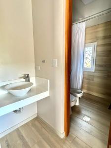 a bathroom with a sink and a toilet at Tres Vientos - Lofts de Montaña Raco in Raco