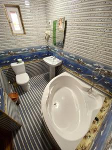 a blue and white bathroom with a tub and a sink at Hotel Rahmon in Samarkand +14 photos