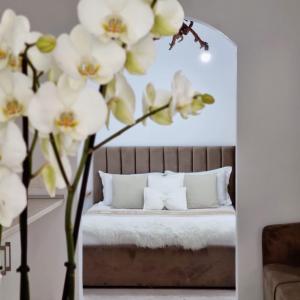 a bedroom with a bed with white flowers at Green Villa in Vlorë
