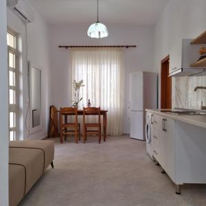 a kitchen and living room with a refrigerator and a table at Green Villa in Vlorë