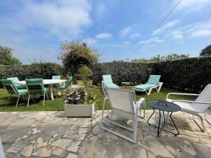 a group of lawn chairs and a table and chairs at Appartement entre 2 plages in Bidart +10 photos
