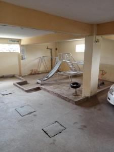 an empty room with a slide and a playground at Georgia Furnished Apartments in Machakos