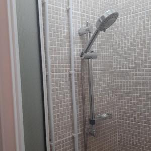 a shower with a shower head in a bathroom at HAVEN HOUSE in Larnaca +29 photos