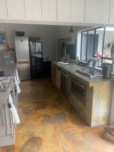 a kitchen with a stove and a refrigerator at Beach Cottage in Le Bois-Plage-en-Ré