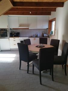 a kitchen with a table and chairs in a room at Gotland, Hästgård i Stånga in Stånga