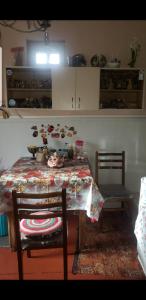 a kitchen with a table and two chairs and a table and chairsktop at Guest House Dodo in Stepantsminda
