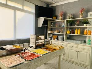 a kitchen with a buffet of food on a counter at Hotel VIDA Xunca Blanca in Sanxenxo