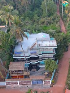 an aerial view of a resort with a swimming pool at Tropical Wave Hostel Morjim in Morjim