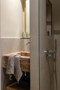 a bathroom with a wooden sink and a shower at Agrinio ART Suites in Agrinion